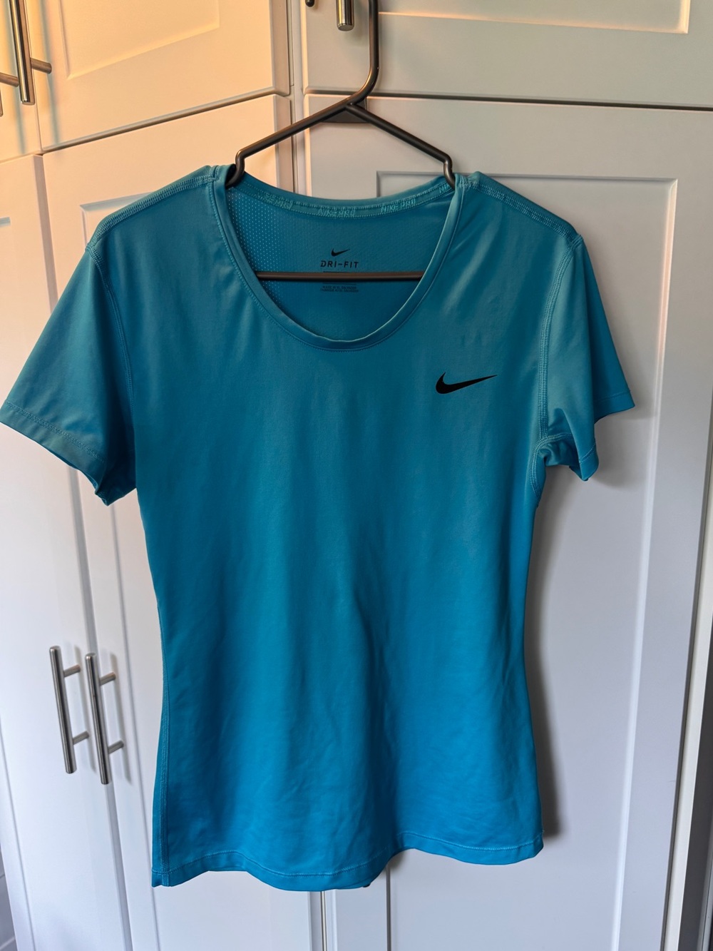 Nike Women's Short Sleeve Dri-FIT Tee in Bright Teal with Black Swoosh